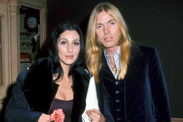 Gregg Allman and Cher taking a photo together.
